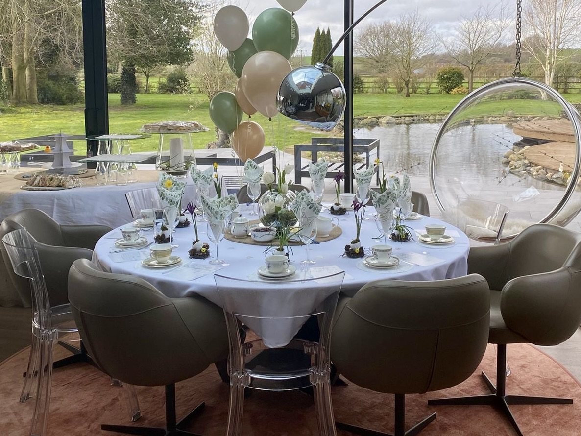 Table styling at Lydia’s baby shower, with spring flowers, patterned china and botanical napkins.